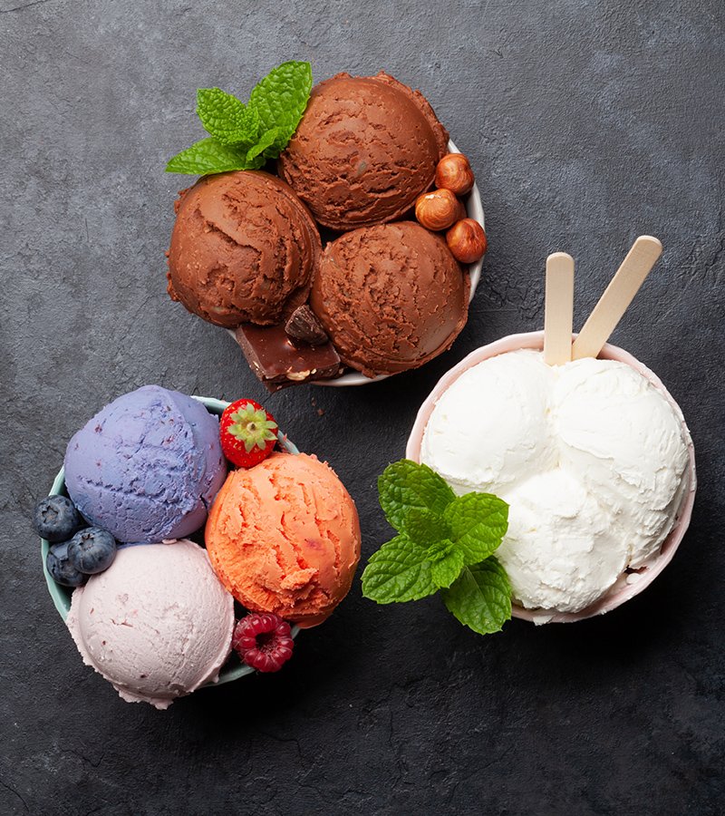 Berry, vanilla and chocolate ice cream sundae. Top view flat lay with copy space