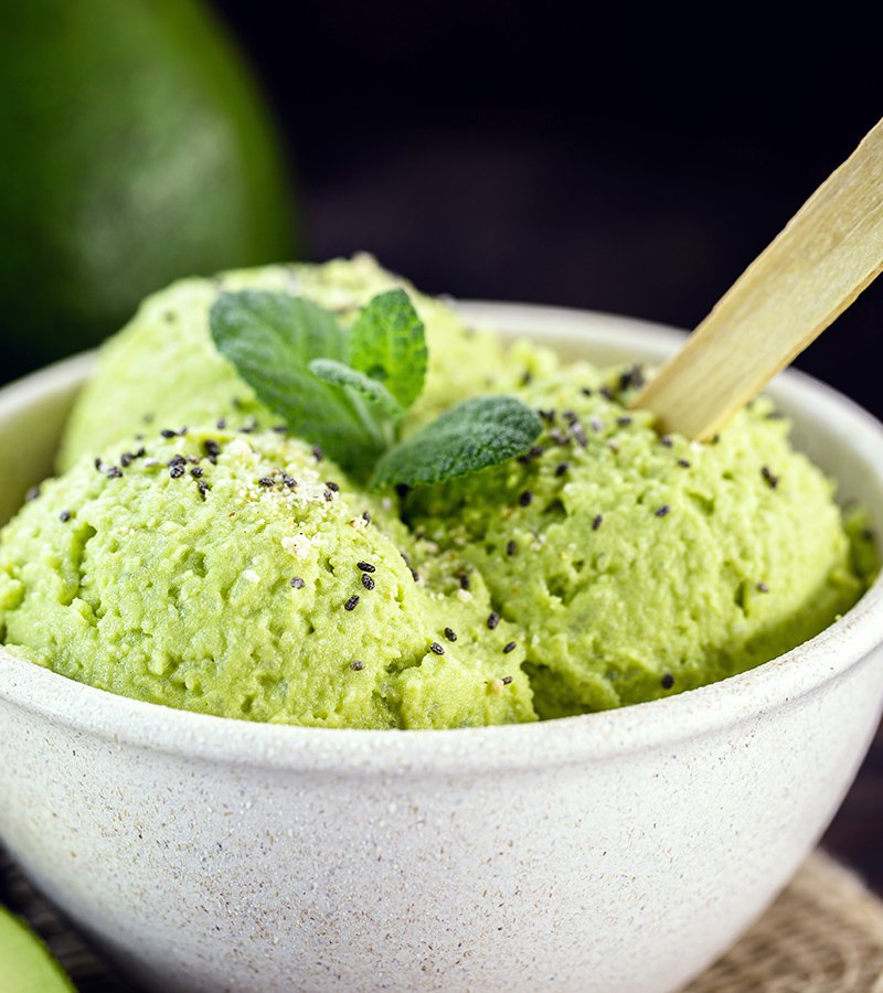 homemade avocado ice cream, made with frozen organic fruits with no added sugar or dairy. Vegan dessert. Dessert served in biodegradable plastic bowl.