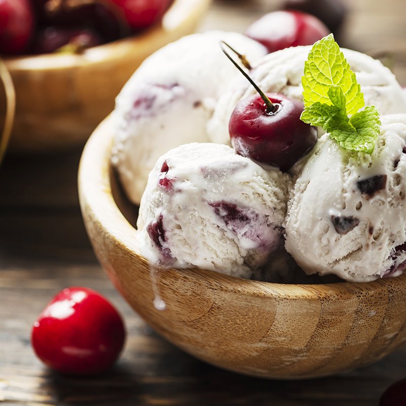 Italian tasty ice-cream with cherry and mint, rustic style and selective focus