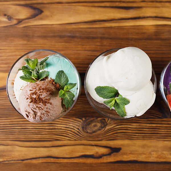 Summertime. Ice-cream scoops in glass sundae bowls. Holiday, vacation, summer delicious refreshing treats